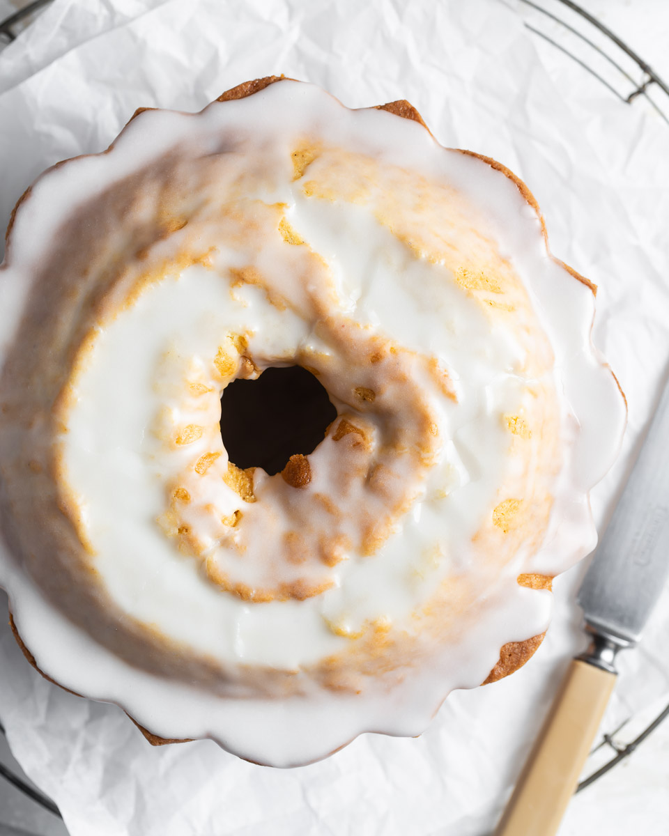 overhead view of glazed donut cake on cooling rack